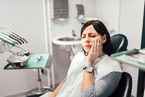 Woman with toothache at dentist’s