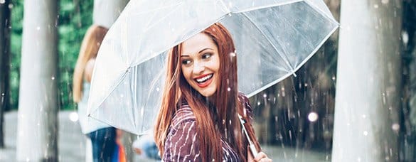 Smiling woman under umbrella